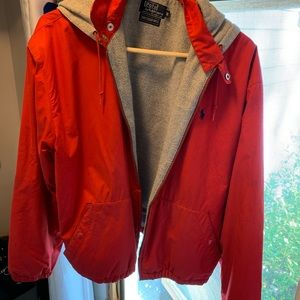 Polo fully lined hooded jacket. Zipper and snaps. Red with blue polo symbol.